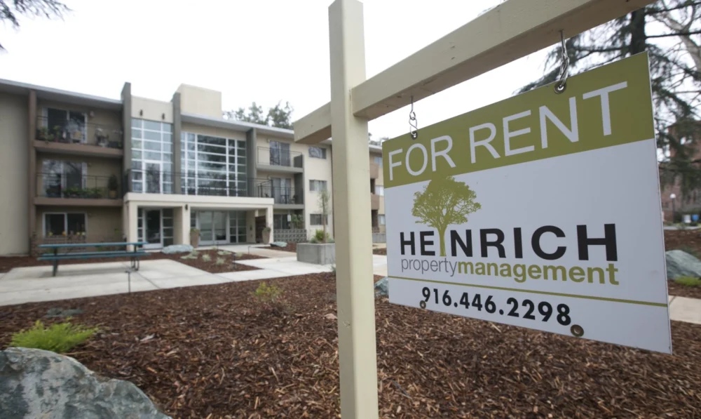 A for rent sign in front of an apartment building