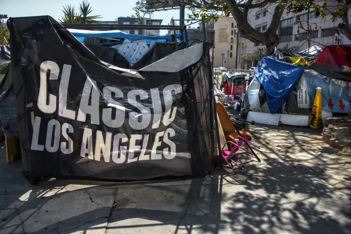 Tent with a banner reading ‘CLASSIC LOS ANGELES’ in a homeless encampment.